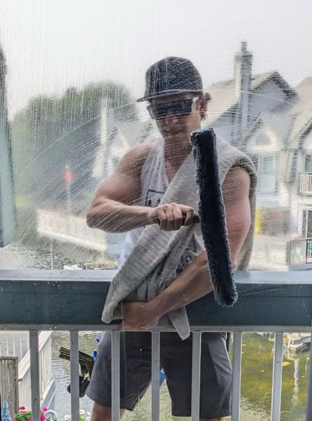 Professional window cleaner at work — Lakeside Window Cleaning, Oakville & Orillia